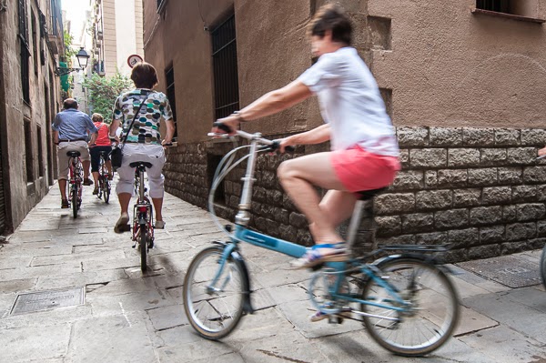 One of our clients making a turn on one of the narrow streets of Barcelona's Old City during a bike tour.