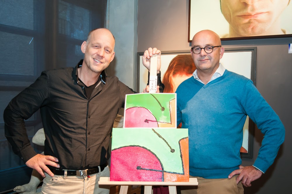 Two employess are pleased with the result of their painting workshop during their comapny's employee incentive program in Barcelona.