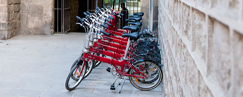Our Dahon private barcelona bike tour bikes lined up while the group explores the interior of this medieval building.